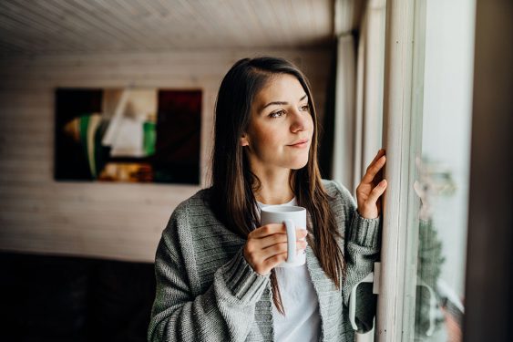 Young woman enjoys morning coffee.